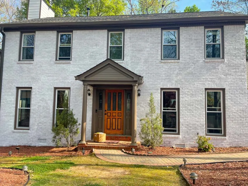 Painted brick home with new black-framed windows